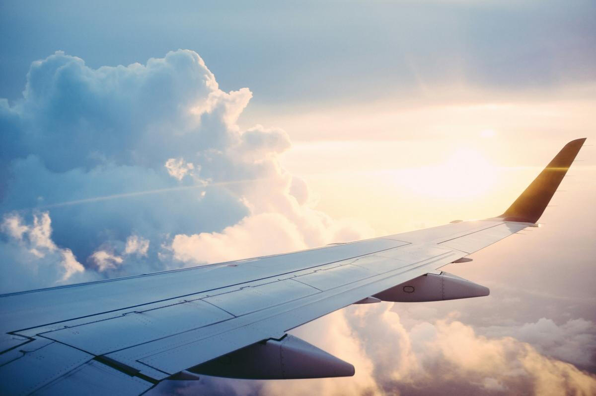 Stunning Sunset Sky View A breathtaking sunset as seen from an airplane window, symbolizing the seamless, luxurious airport transfer experience offered by Princeton Elite Car Service.